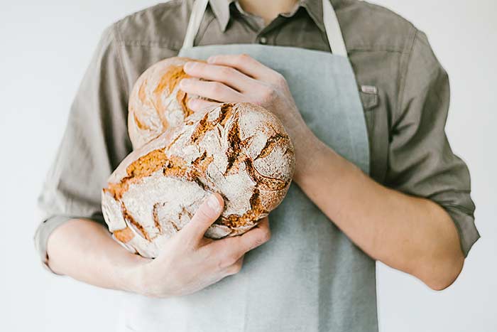baker or chef holding fresh made bread